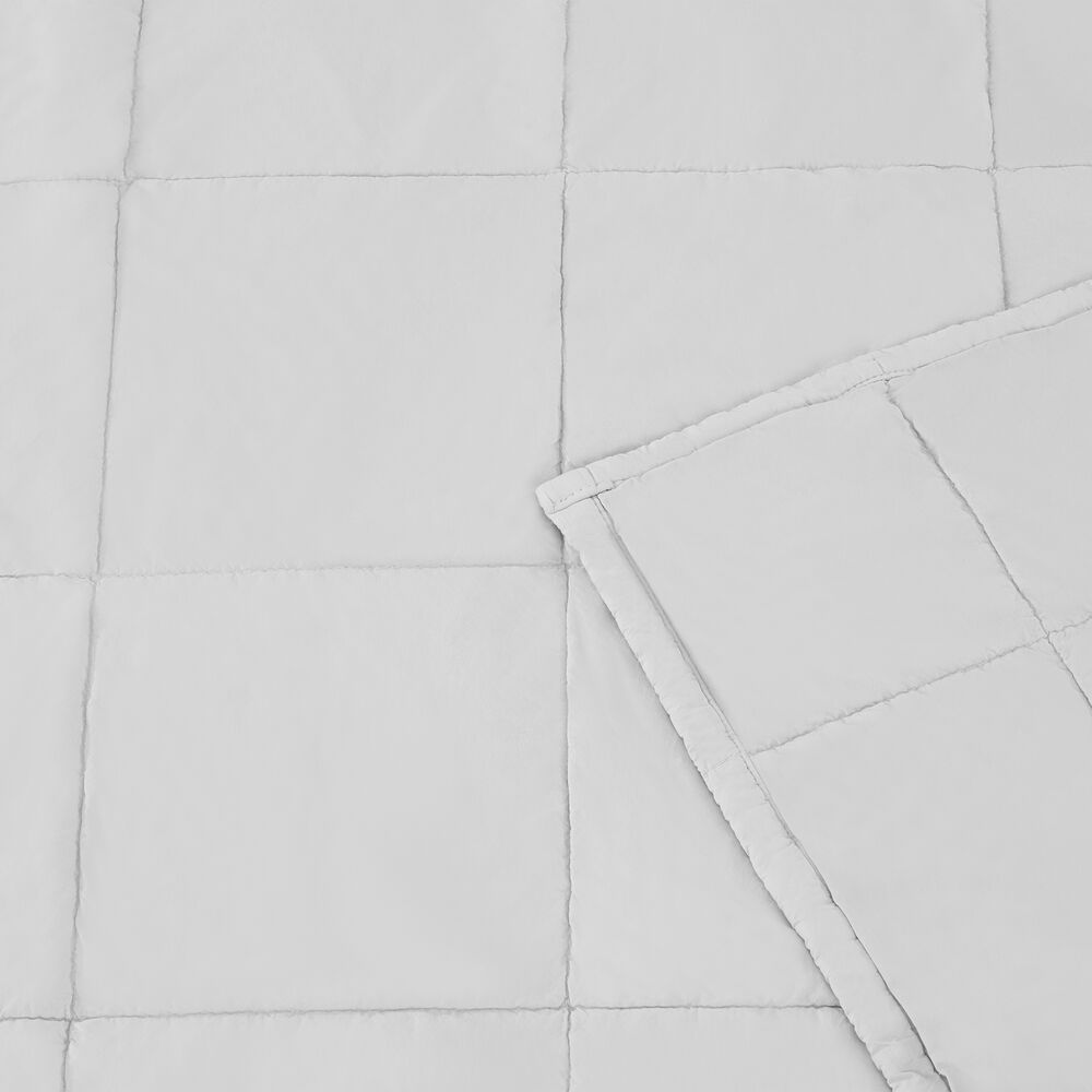 Pumice Stone quilted blanket with a corner folded over on a matching background