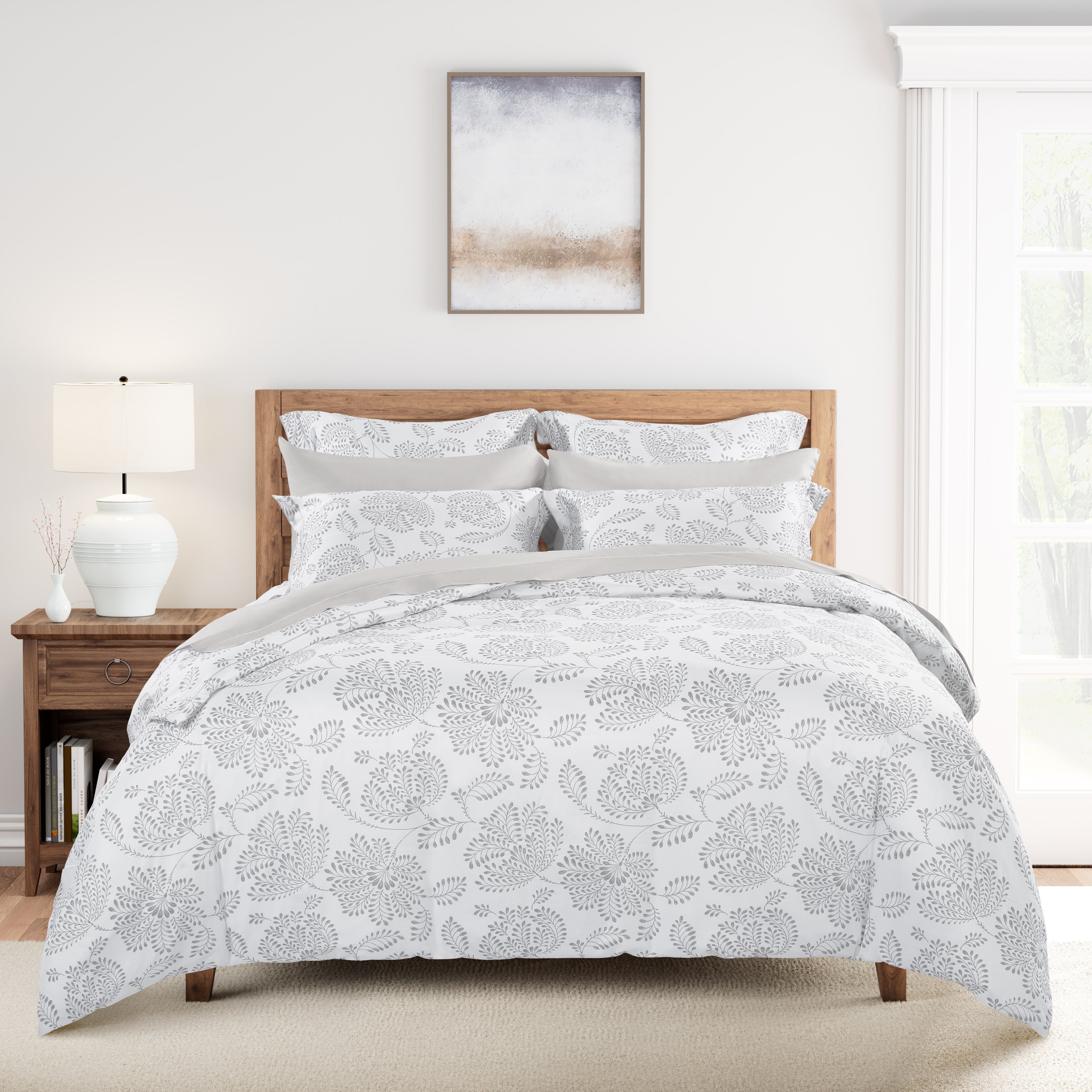Bed with floral-patterned comforter in a bedroom setting