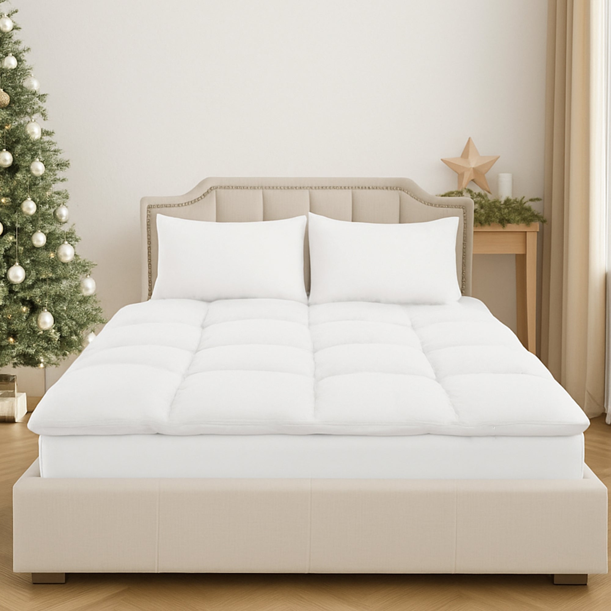 White mattress topper on a bed in a room with a Christmas tree