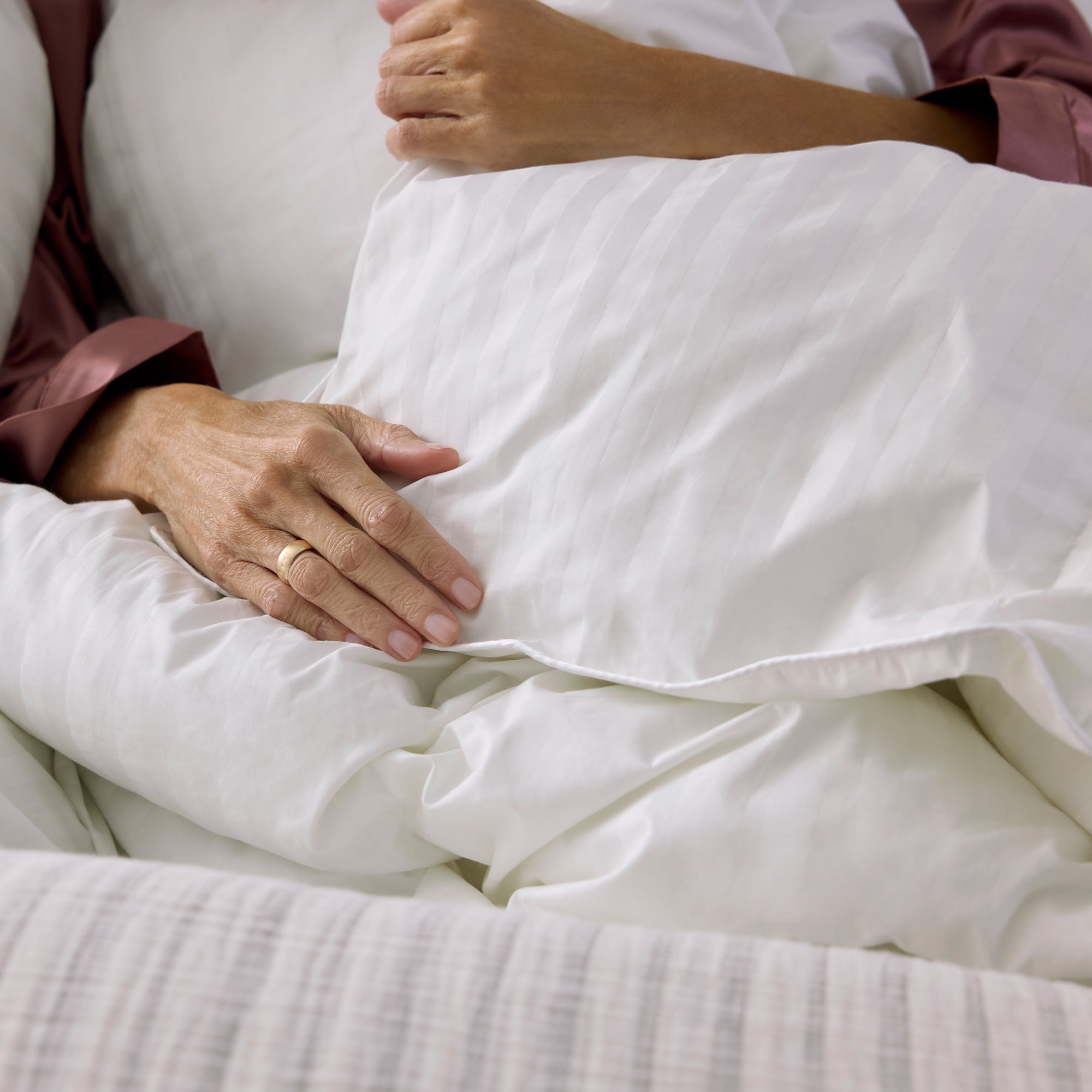 Close-up of a person holding a pillow with a soft texture